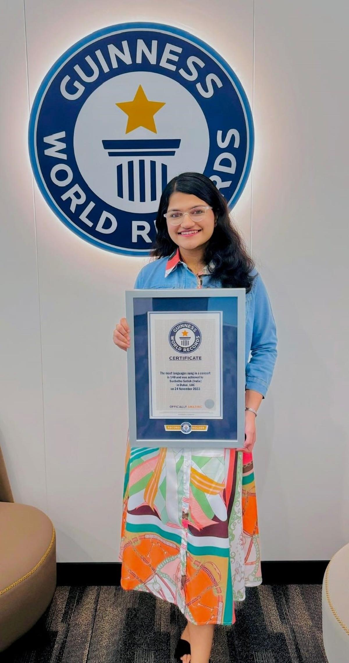 Suchetha Satish with her Guinness World Record certificate for most languages sung in a concert with 140 languages